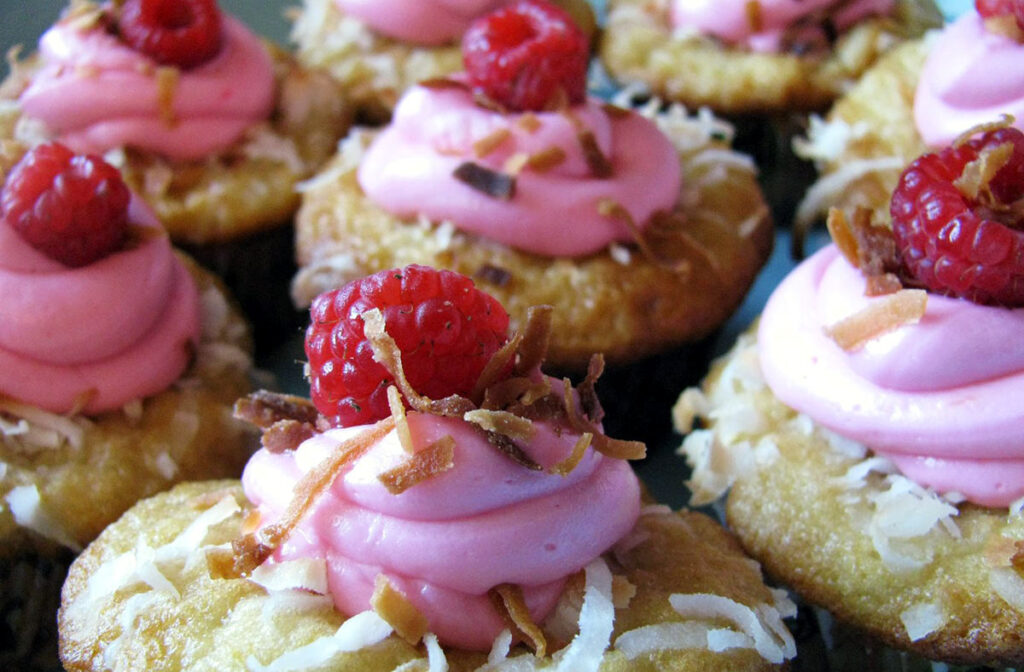 Raspberries on top of cupcakes