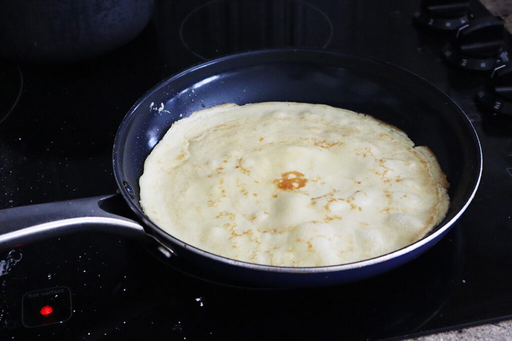 A Crepe Cooking in a Pan