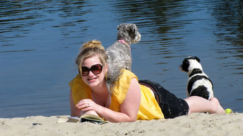 Dog sitting on woman's shoulders