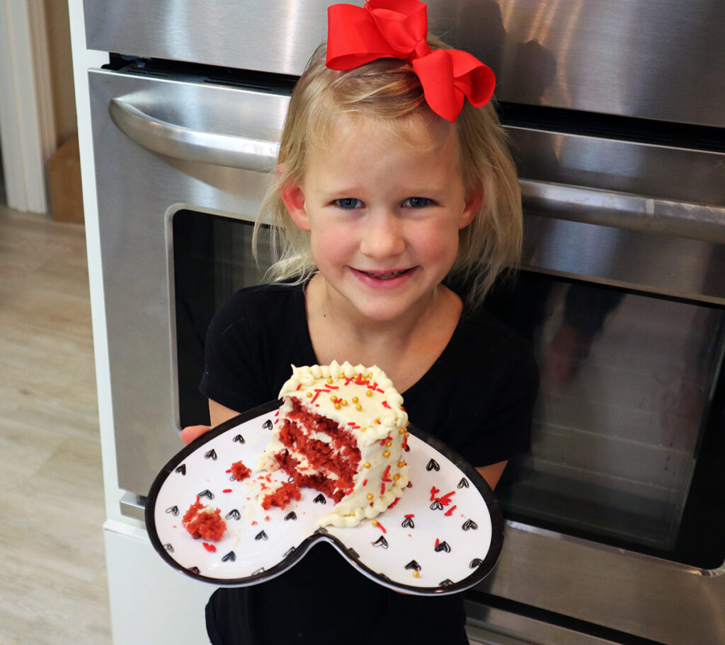Little girl with red velvet cake