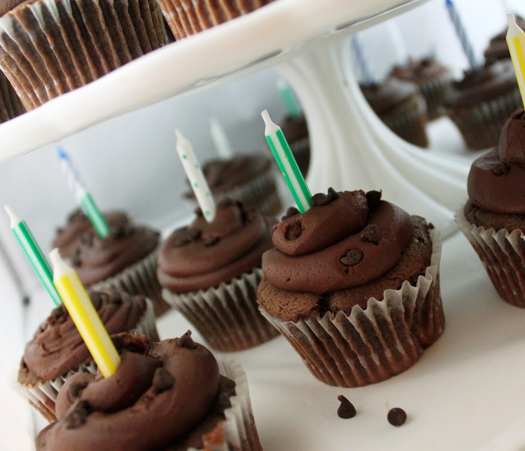 chocolate cupcakes under a cake plate