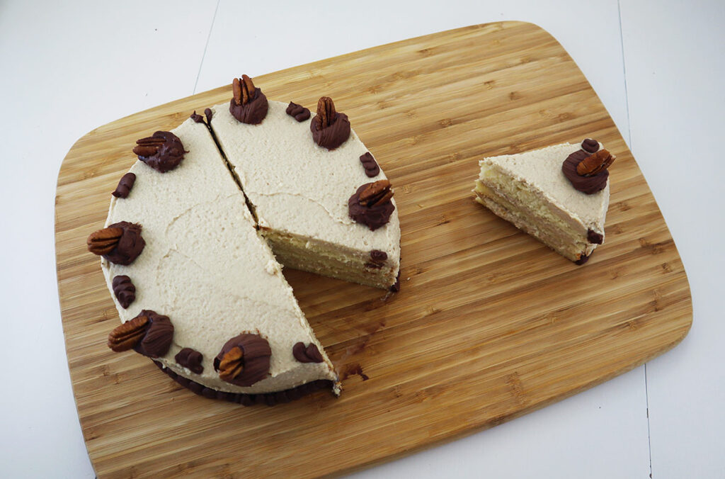 View of White Velvet Cake with Maple Cinnamon Frosting Top Down and a slice Cut Out