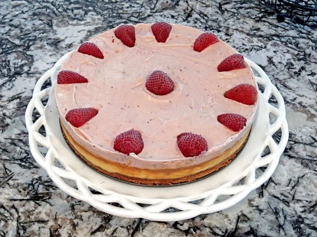 Whole Strawberry Ice Cream Cheesecake with quartered strawberries