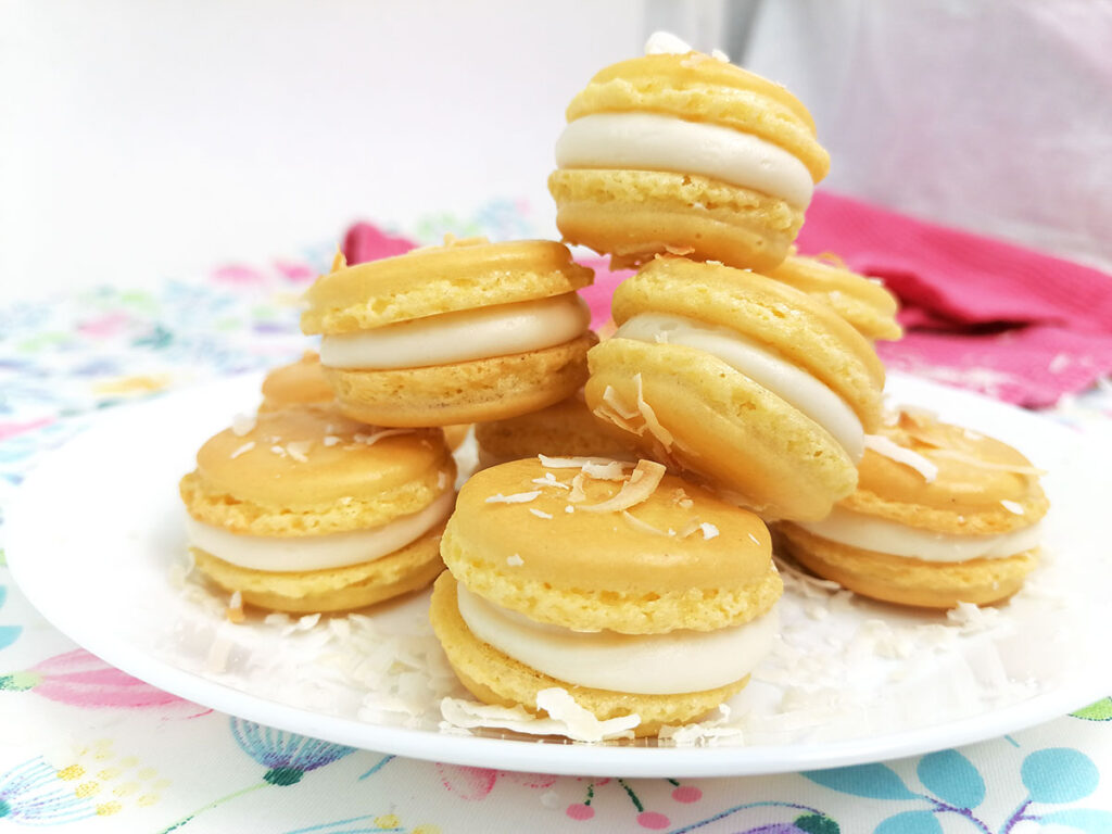Recipe Photo for If you like pina coladas, you’ll love these pina colada macarons made with a coconut cookie shell and filled with a delicious pineapple, coconut, rum frosting.